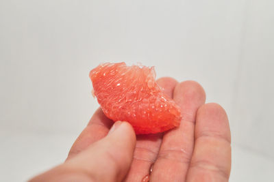 Close-up of hand holding strawberry