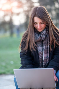 Young woman using laptop at table