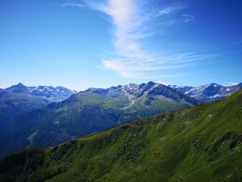 Scenic view of mountains against blue sky