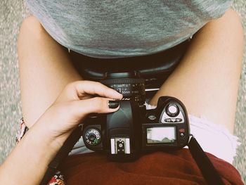 Midsection of man holding camera