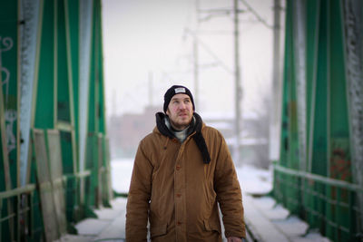 Portrait of young man standing in winter