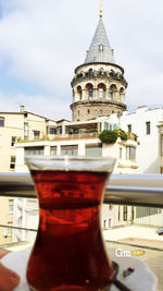 Close-up of drink on table against building in city