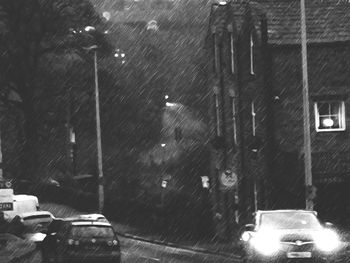 Cars on road in city during rainy season at night