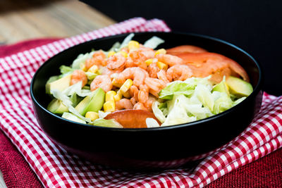 Close-up of salad bowl on napkin