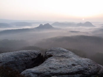 Scenic view of mountains against sky during sunset