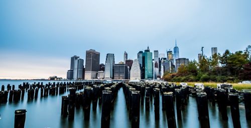 Panoramic view of wooden posts in sea against clear sky