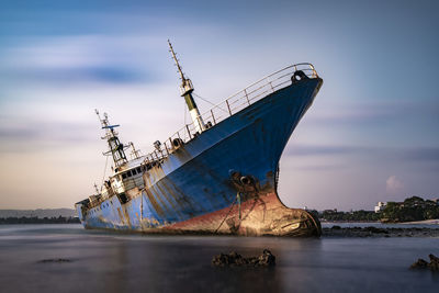 Sailboat in sea against sky