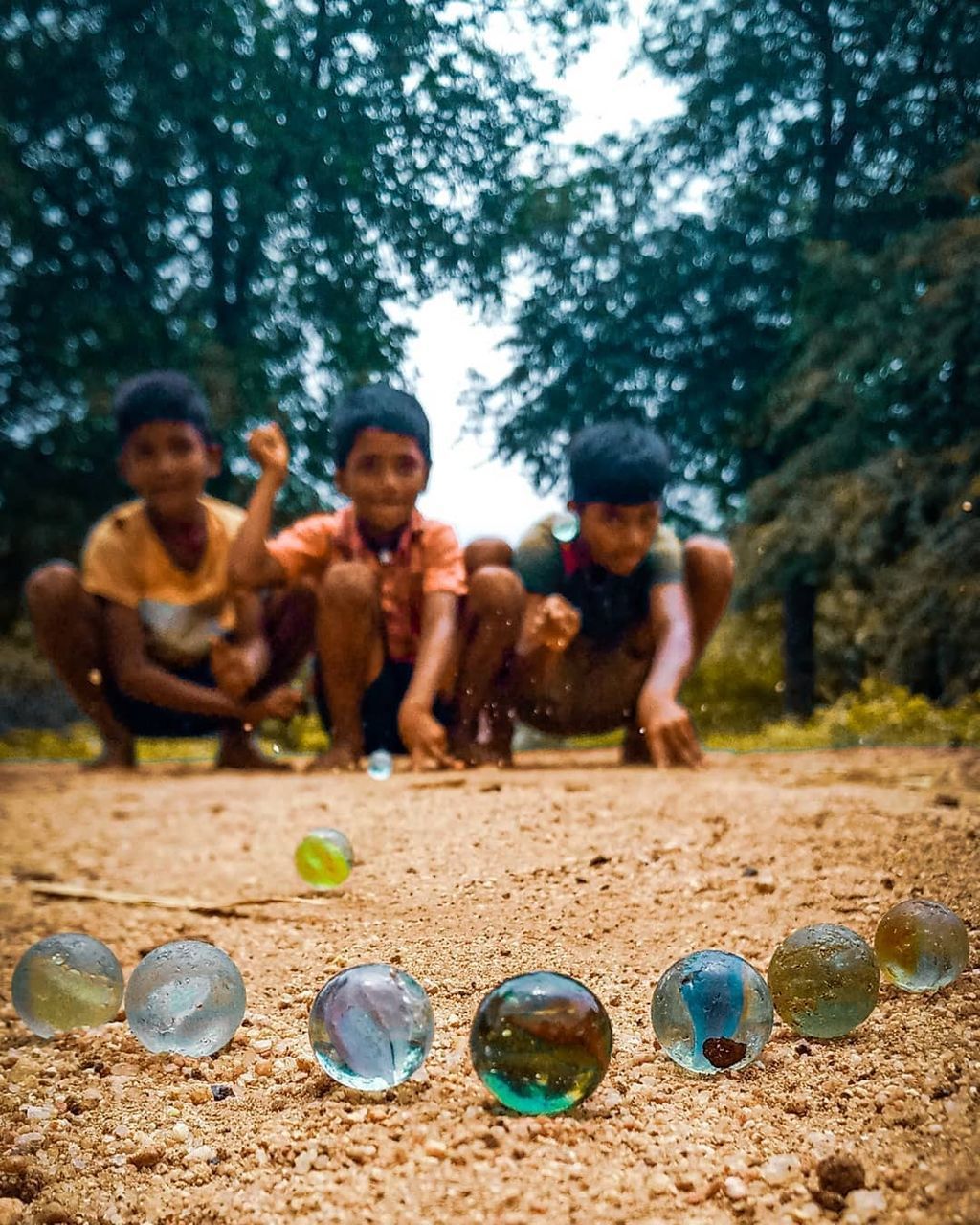 GROUP OF PEOPLE PLAYING WITH BALL ON GROUND