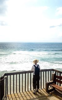 Rear view of woman standing on beach