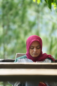 Portrait of young woman standing outdoors