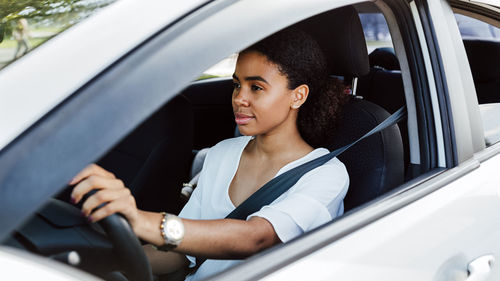 Portrait of woman sitting in car