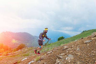 Skyrunner athlete while training for mountain trail with sticks