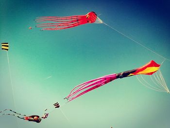 Low angle view of flags hanging against sky