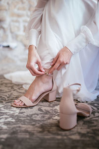 Low section of woman relaxing on floor
