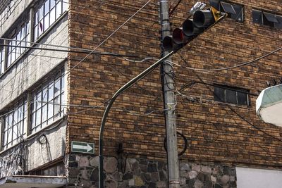 Low angle view of road signal against building