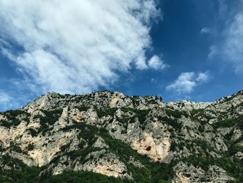 Low angle view of rocky mountains against sky