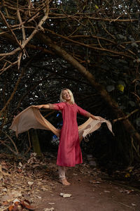 Portrait of woman standing in forest