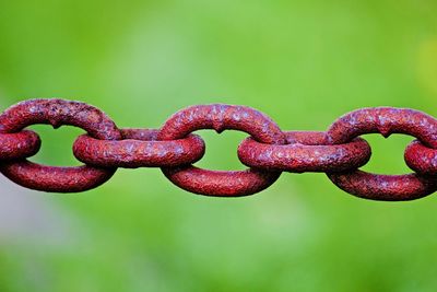 Close-up of metal chain against blue background