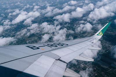 Aerial view of airplane wing against sky