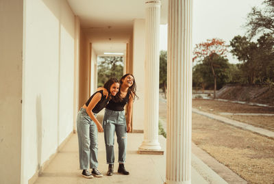 Women standing and laughing in corridor