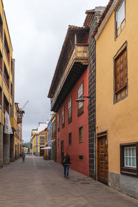 Street amidst buildings against sky