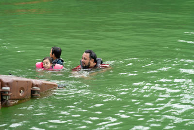 Father with kids enjoying in lake