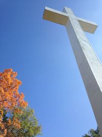 Low angle view of cross against clear blue sky