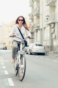 Woman riding bicycle on road