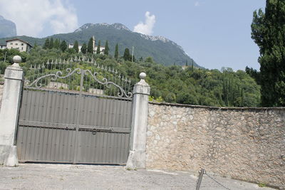 Built structure against trees on mountain against sky