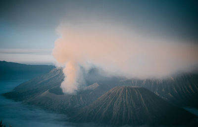 Scenic view of mountains against cloudy sky