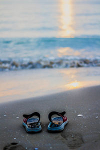 Slippers on beach at sunrise