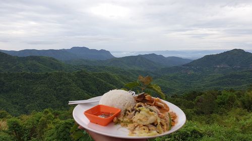 Food on mountain against sky