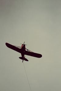 Low angle view of airplane flying in sky