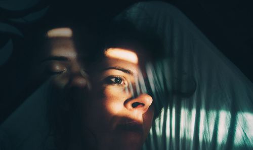 Double exposure of woman on bed