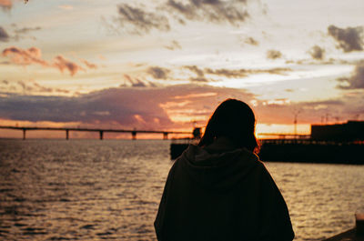 Rear view of woman looking at sea against sky