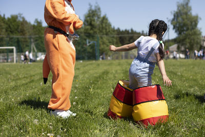 Rear view of boys playing on grassland