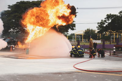 People with fire in the background