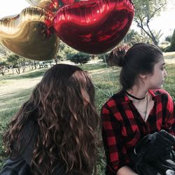 Portrait of girl with balloons at outdoors