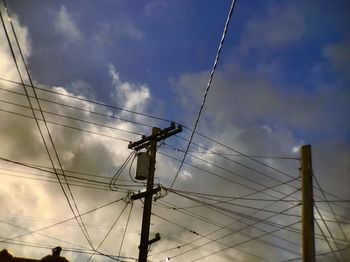 Low angle view of electricity pylon against sky