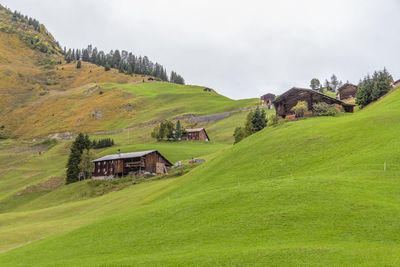 Houses on field against sky