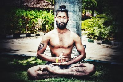 Portrait of young man sitting outdoors