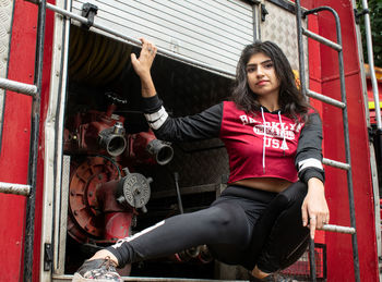 Portrait of young woman sitting outdoors