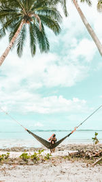 View of fishing net on beach against sky