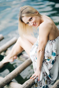 Midsection of woman sitting in water