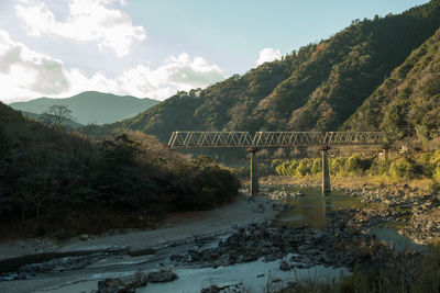 Bridge over mountains against sky