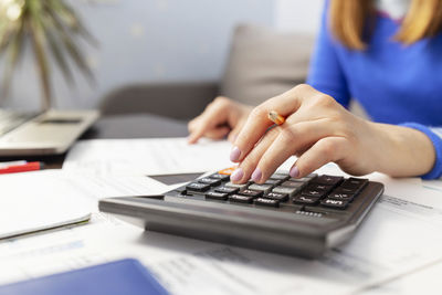 Midsection of woman using laptop on table