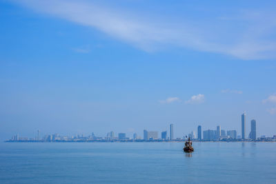 Scenic view of sea against sky in city