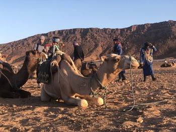 Panoramic view of people on desert against sky