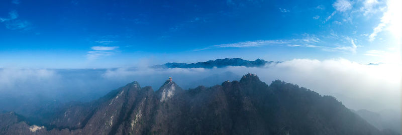 Panoramic view of mountains against cloudy sky