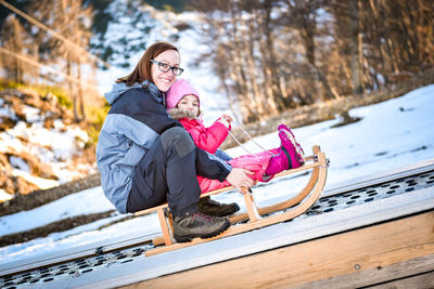 Happy woman with girl during winter